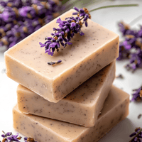 Stack of natural lavender comfrey soap bars with fresh lavender flowers on a light background at House of Agave.