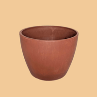 Terracotta-colored planter on a green background from House of Agave.