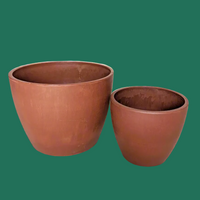 Two terracotta pots for compact houseplants against a plain background.