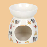 Ceramic oil burner with butterfly designs on a white background