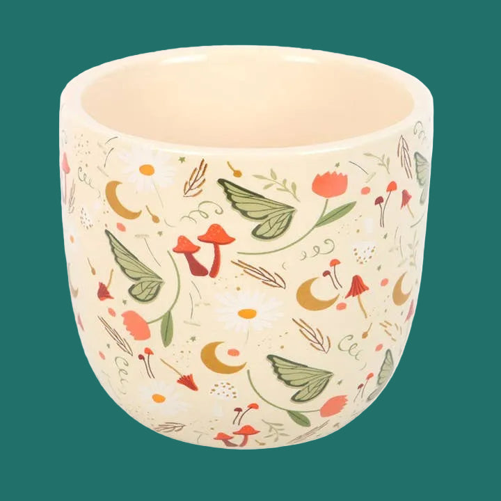 Ceramic planter with nature-themed design on a white background